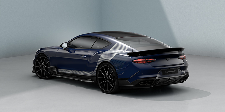 Bentley Köln Bentley Supersports rear three quarter in "Skies" Design theme with Electric Blue paint finish and Arctica white and Oxford blue paint stripes across the rear haunch.